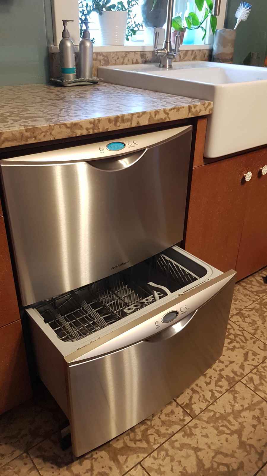 Dishwasher installed beside a kitchen sink