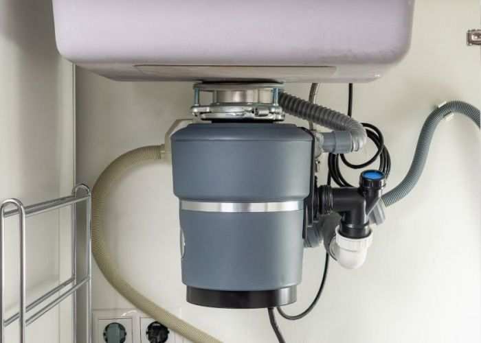 Garbage disposal unit mounted under a kitchen sink